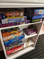 Full view of shelf with multiple boxed games