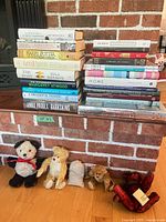 Overall view of both book stacks on hearth with four teddy bears below
