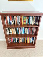 Front view of wood bookcase with three shelves