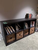 Front view of cube bookshelf with baskets and books for scale