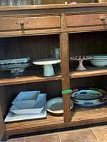 Cabinet interior showing all cake stands, bowls and platter