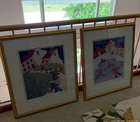 Both framed Carol Ann Shelton prints side by side