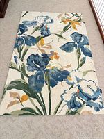Top view of full rug showing floral pattern and overall condition