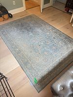 Full view of blue Magnolia Home rug on floor