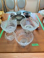 Overview showing crystal bowls and part of stoneware and ceramic pieces within lot boundaries