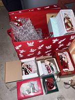 Red storage bin with boxed ornaments visible