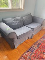 Front view of blue sofa with removable cushions