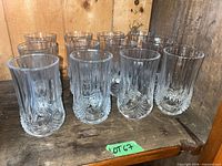 Twelve matching cut crystal Longchamp highball glasses arranged on shelf