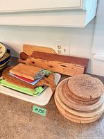 Stacked lot showing wood, plastic, cork boards