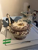 Overview of tureen, pitcher and figurine together