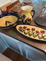full view of bowl, pitcher, and platter on countertop