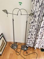 Full view of both matching floor lamps with bases, poles, shades and cords