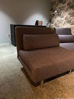 Angled side view highlighting profile, cushion, and metal legs