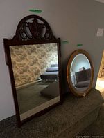 Both mirrors leaning against wall showing size and styles