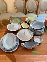 Assorted blue and green Petalware dishes on table