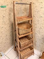 Front view of wooden ladder shelf with three baskets
