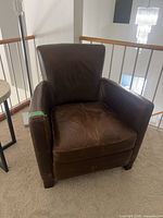 Front view of brown leather armchair