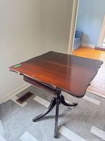 Top view of mahogany folding card table unfolded