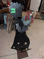 Full view of metal angel sculpture with wings and pail