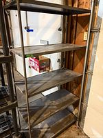 Front view of full metal shelving unit with six shelves