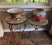 Overall view of two mosaic tables and two ceramic planters