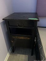 Front and top view of nightstand against wall