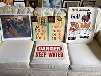 Group view of all four unframed prints/posters on sofa