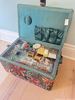 Open sewing basket showing tray with sewing notions