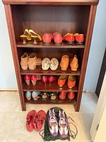 Full bookshelf showing majority of shoe pairs and wooden lasts
