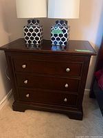 Front view of dark wood 3-drawer Stanley dresser with drawers closed