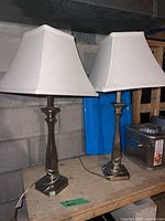 Full view of both matching metal lamps with shades