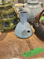 Group view of four teapots on counter