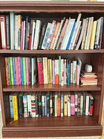 Front view of three-shelf bookcase filled with books