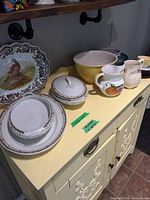 Overview of all china, pitchers and bowls on cabinet