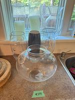 Group shot of all vases on countertop near window