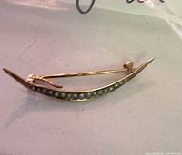 Front view showing crescent shape and seed pearl row