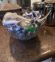overall view of punch bowl containing ladle and cloth