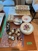 Overview showing stacks of plates, tray, metal and glass napkin rings