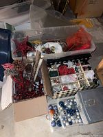 plastic totes with assorted ornaments, red star topper, decorative picks, compartmented ornament box