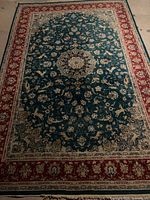 Full view of green-blue and red Persian rug