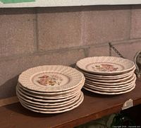 Stack of nineteen Royal Doulton Grantham salad plates on shelf