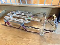 Full view of wooden slat sled with metal runners