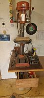 Full view of drill press on workbench with attachments