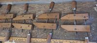 Five wooden Jorgensen clamps laid out showing size difference