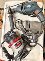 Overview of three corded power tools on table