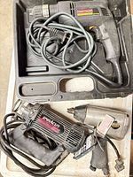 All three tools with cords inside and around carrying case