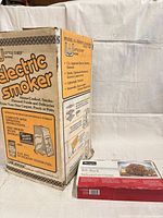 Little Chief electric smoker carton with Charmglow rib rack box beside