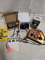All items group shot showing controller, moisture meter, wireless charger, dial indicator, Rain-X, Slide Free Pad, cables