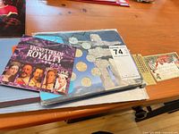 Overview of Olympic coin folder, Millennium set underneath, Vignettes booklet on top