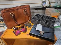 Group shot showing handbag, clutch, sunglasses pairs, beaded organizer tray
